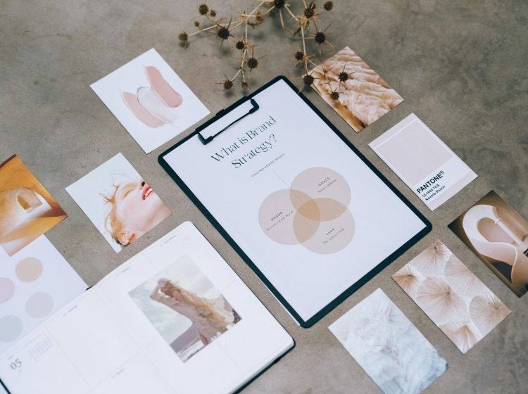 Flat lay of a minimalist brand strategy moodboard on a concrete surface.